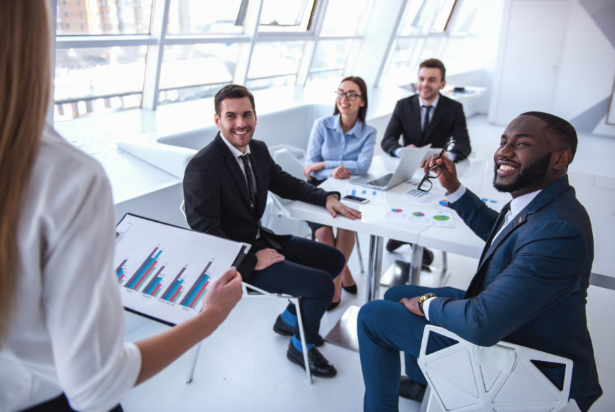 Business professionals engaged in discussion in a meeting room, exploring social media engagement and its impact on sales.